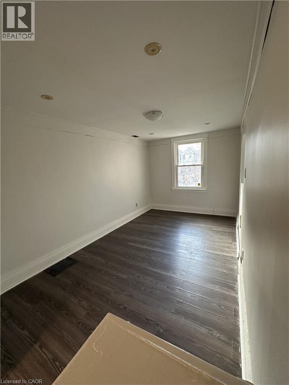 A room with wooden floors and a window.