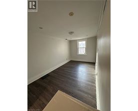 A room with wooden floors and a window.