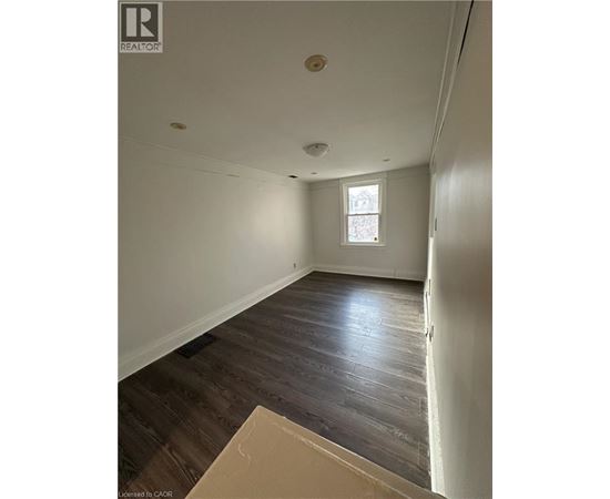 A room with wooden floors and a window.
