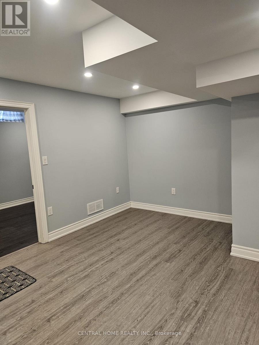 A room with grey walls and a wooden floor.