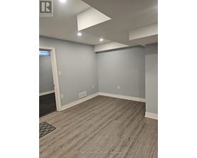A room with grey walls and a wooden floor.