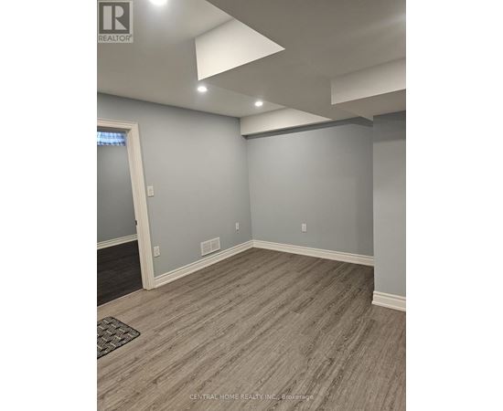 A room with grey walls and a wooden floor.