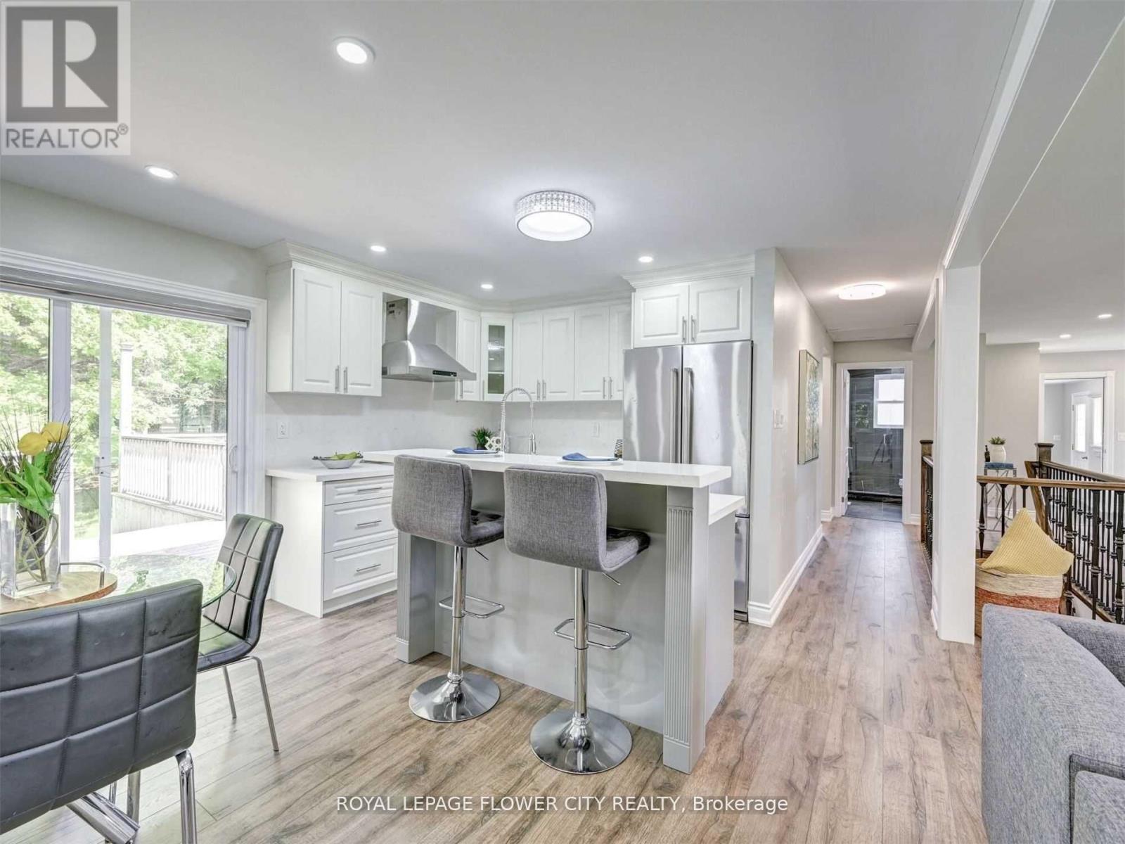 A modern kitchen with a dining table and chairs.