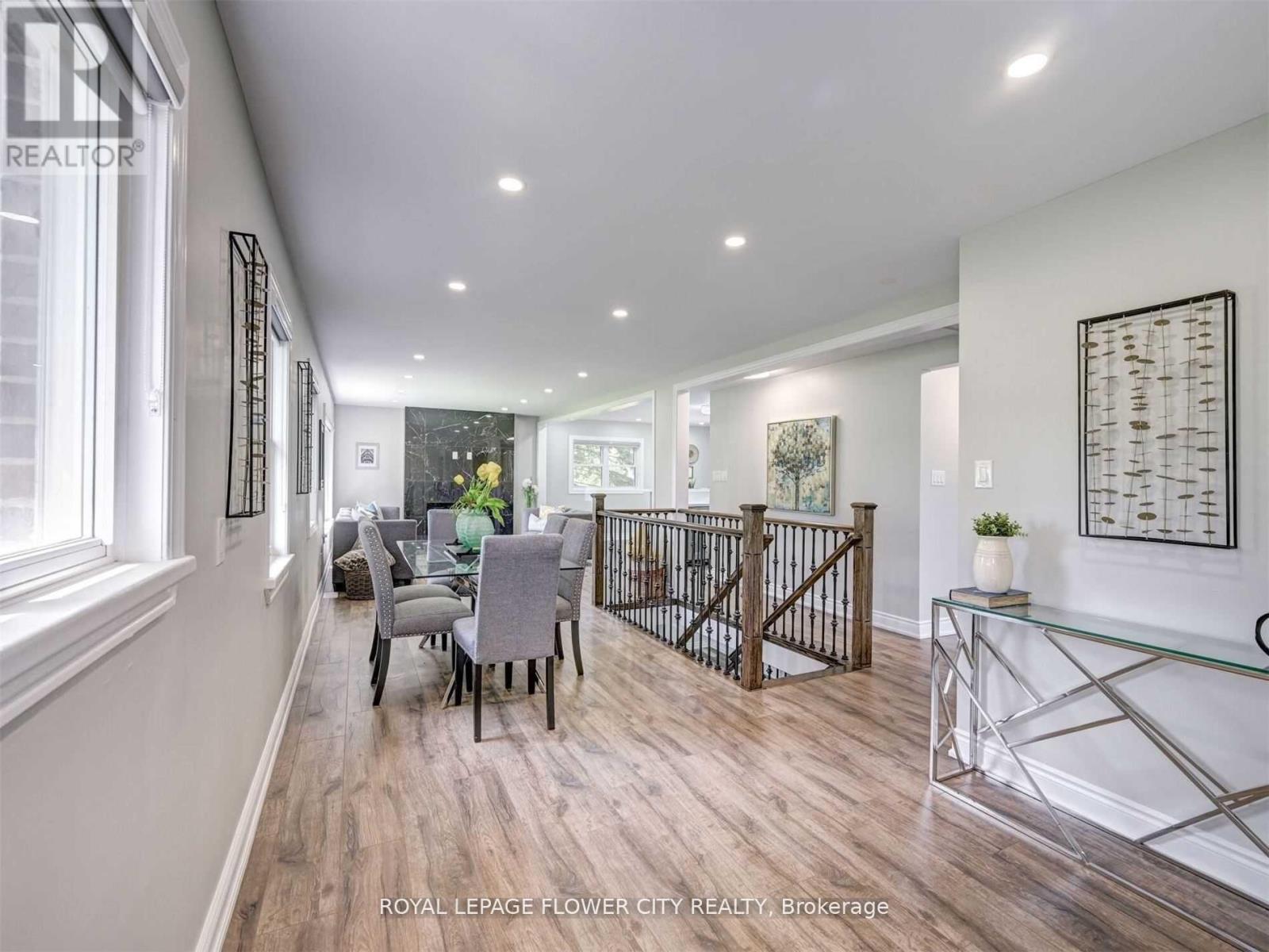 A spacious room with a dining table and chairs.