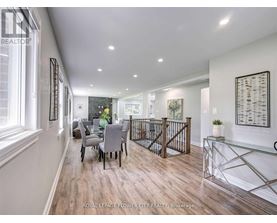 A spacious room with a dining table and chairs.