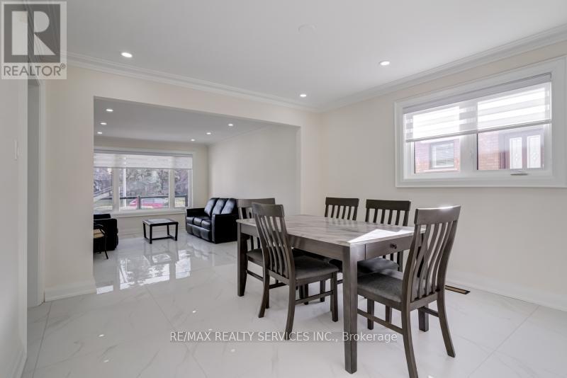 A dining room with a table and chairs.