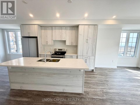 A kitchen with a sink and a stove top oven.