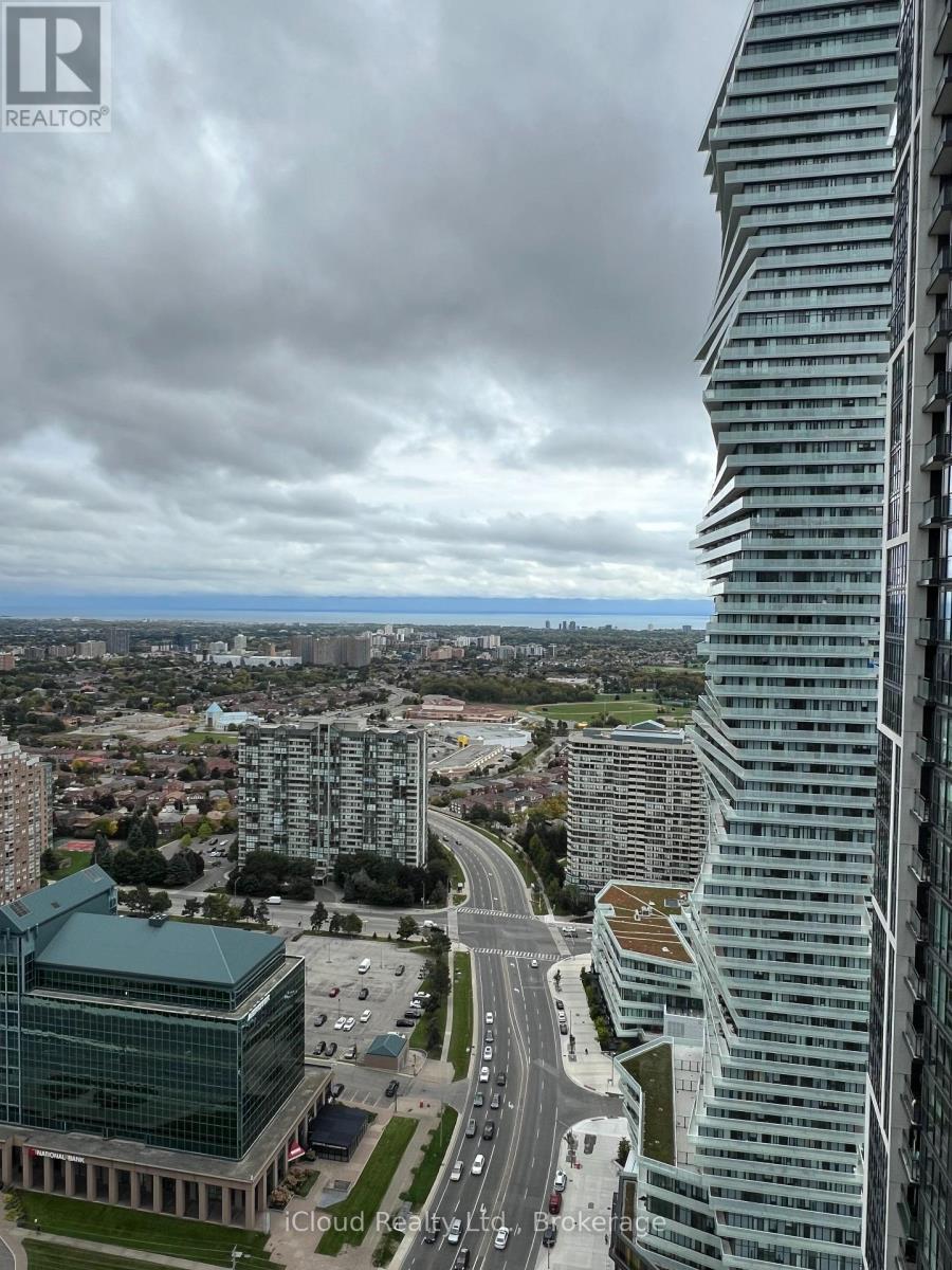 A tall building stands in the foreground of a cityscape.