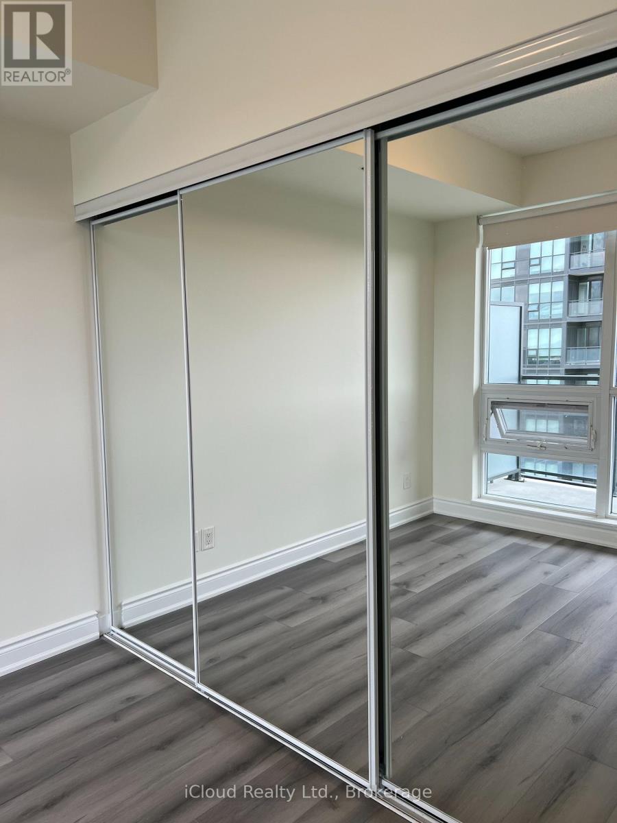 A room with a sliding glass door leading to a balcony.