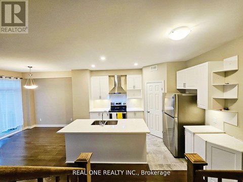 A kitchen with white cabinets and a large island.