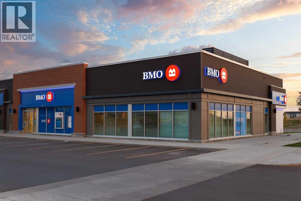 The exterior of a BMO bank branch with a blue sky in the background.