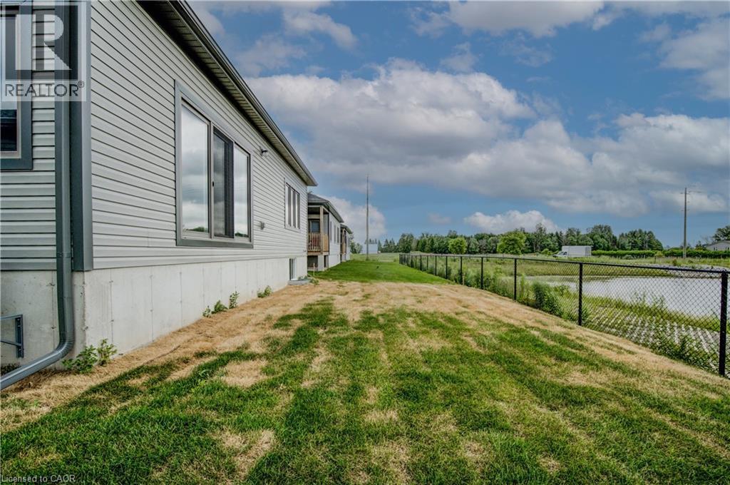 A grassy pathway leads to a building with a sign that says REALTOR.