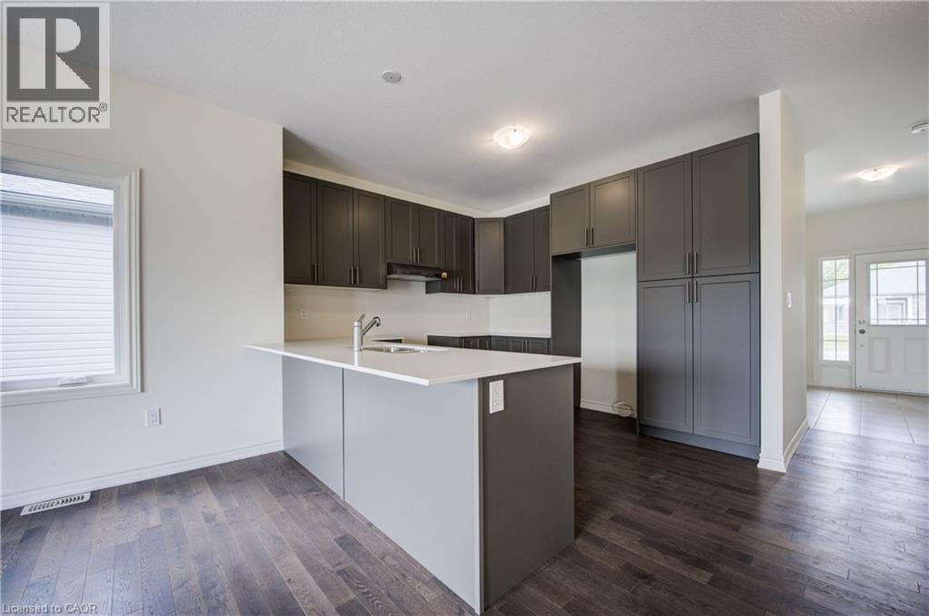 A kitchen with dark brown cabinets and a white counter.