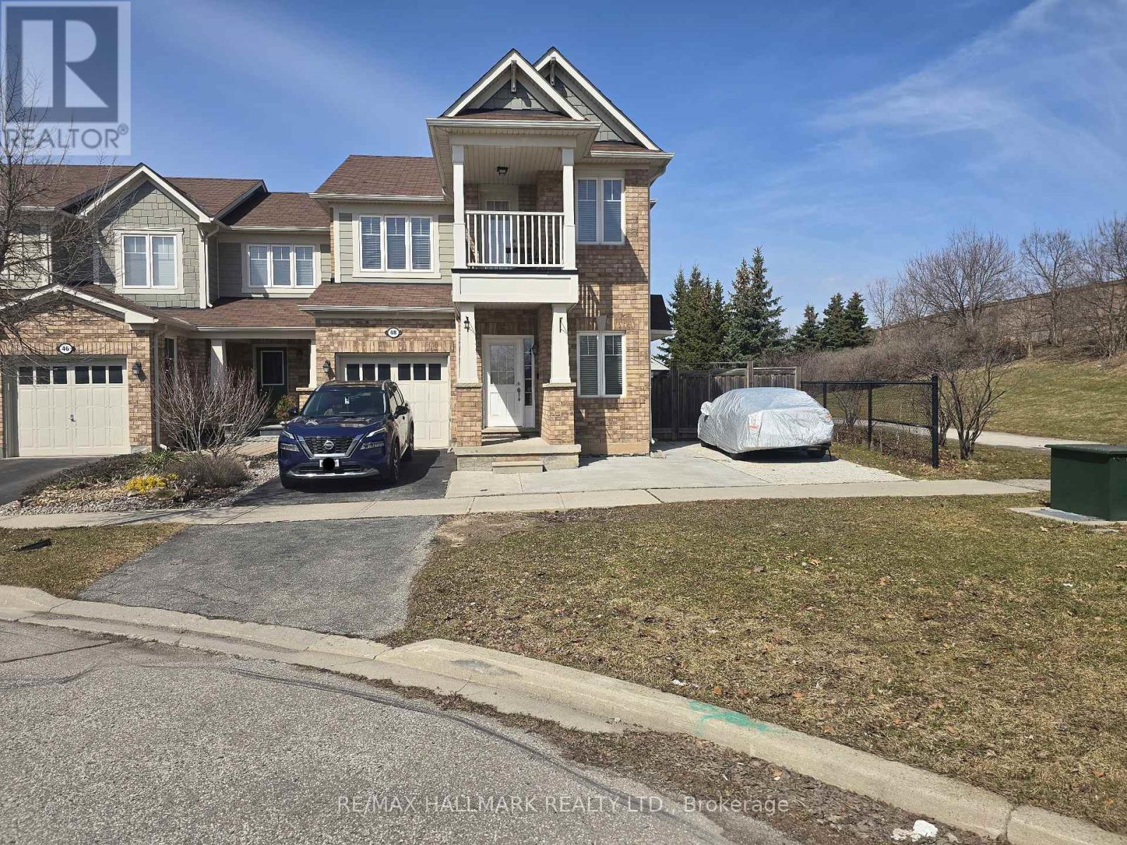 A large house with a car parked in front.