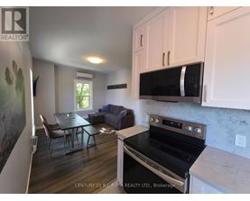 A kitchen with a stove top oven and a microwave above it.