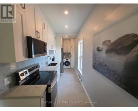 A kitchen with a stove top oven and a microwave on the counter.