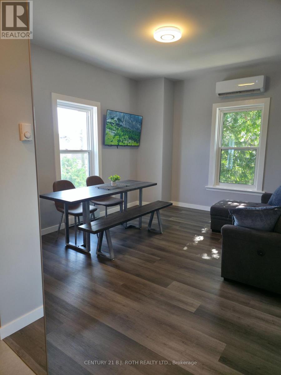 A living room with a table and chairs.