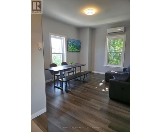 A living room with a table and chairs.