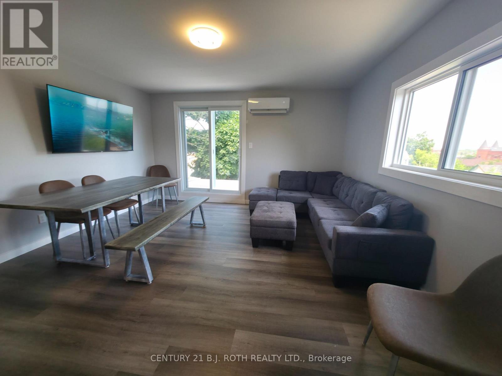 A living room with a couch, table, and chairs.