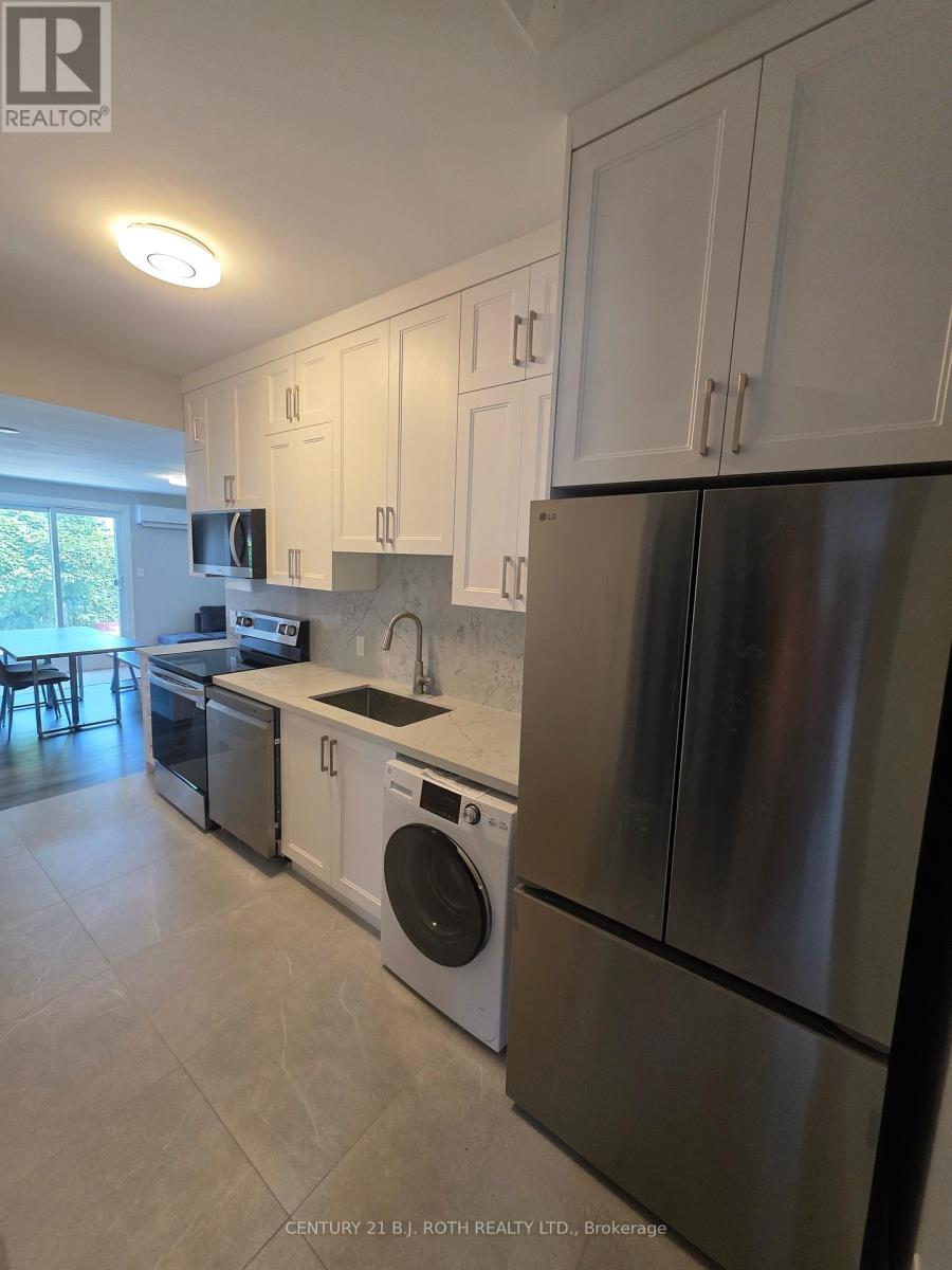 A kitchen with white cabinets and stainless steel appliances.