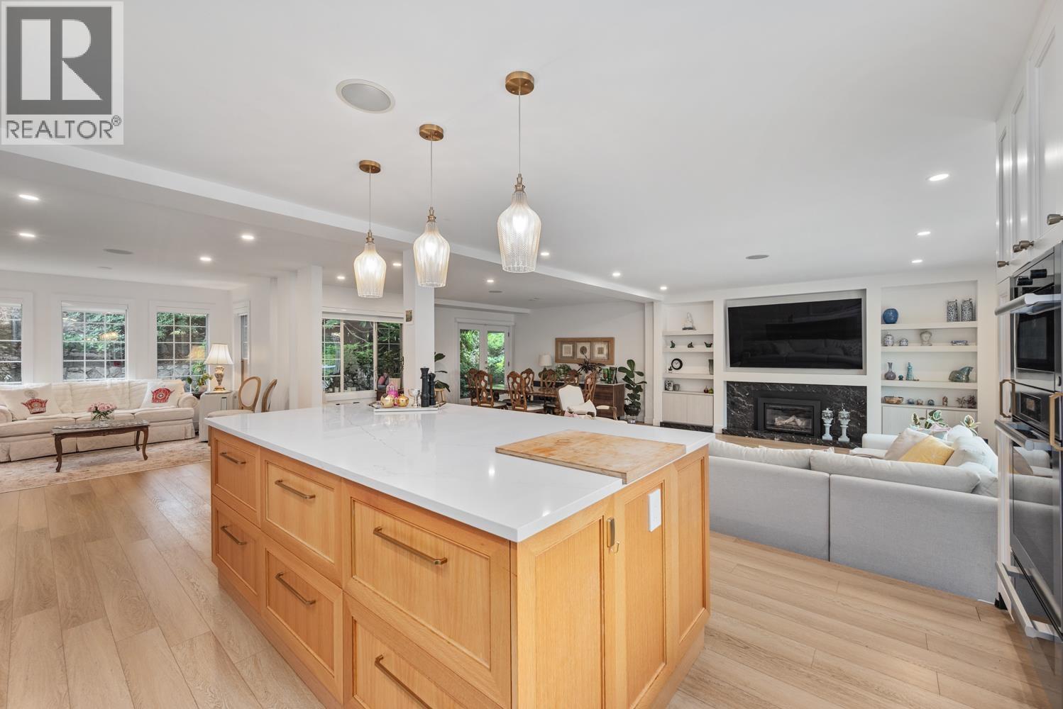 A modern kitchen with wooden cabinets and a large island.