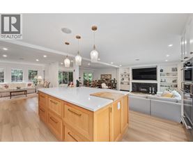 A modern kitchen with wooden cabinets and a large island.