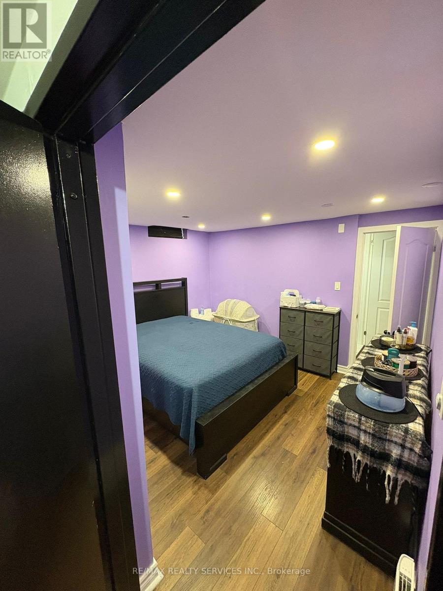 A bedroom with a bed, dresser, and nightstand.