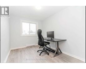 A room with a desk and a computer chair.