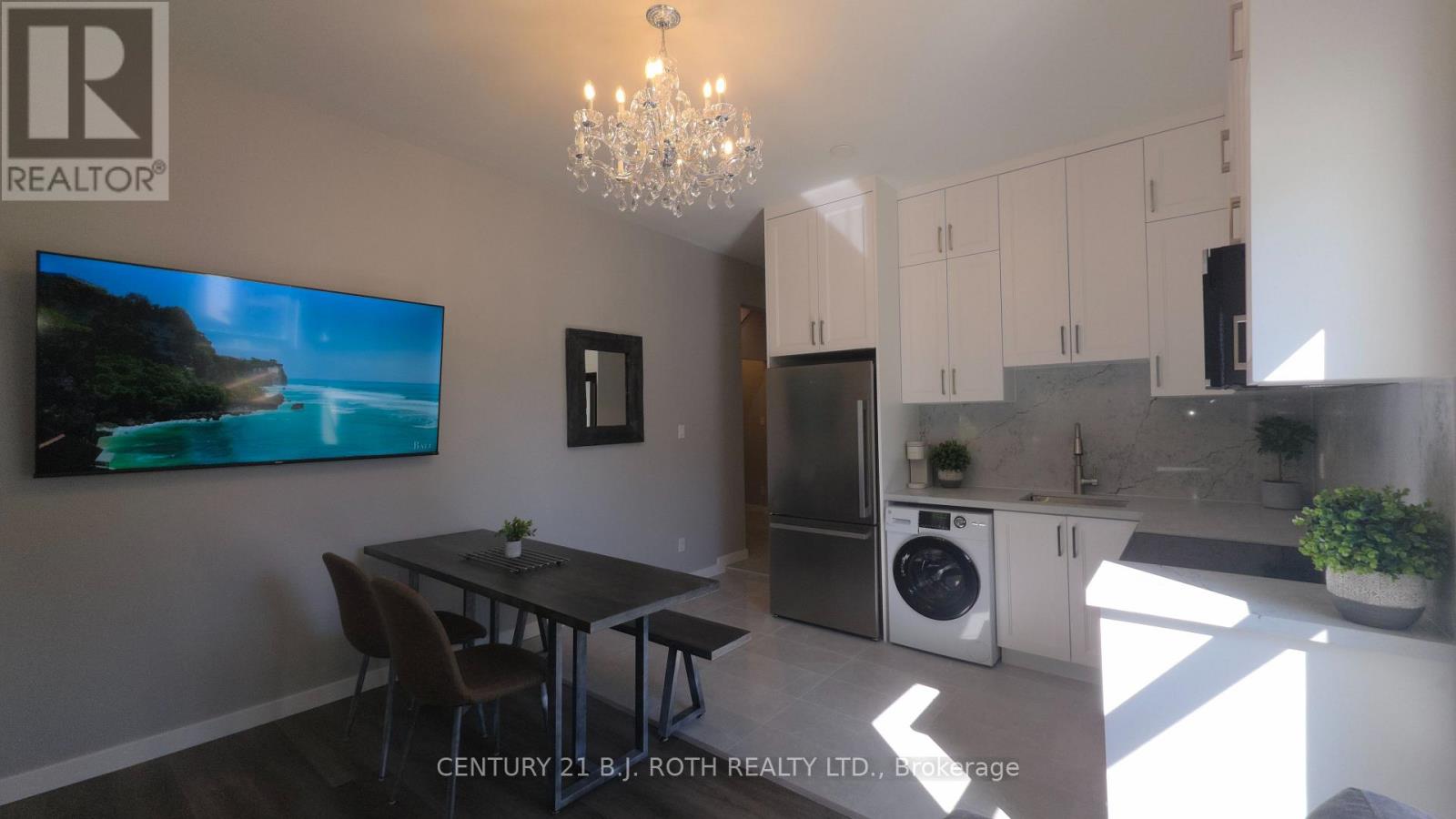 A modern kitchen with a dining table and chairs.