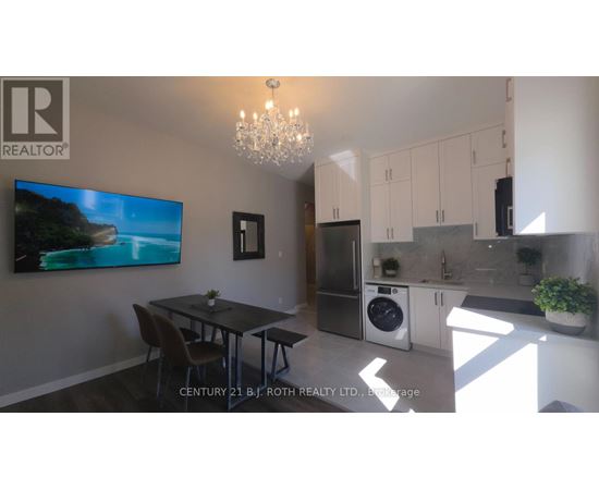 A modern kitchen with a dining table and chairs.