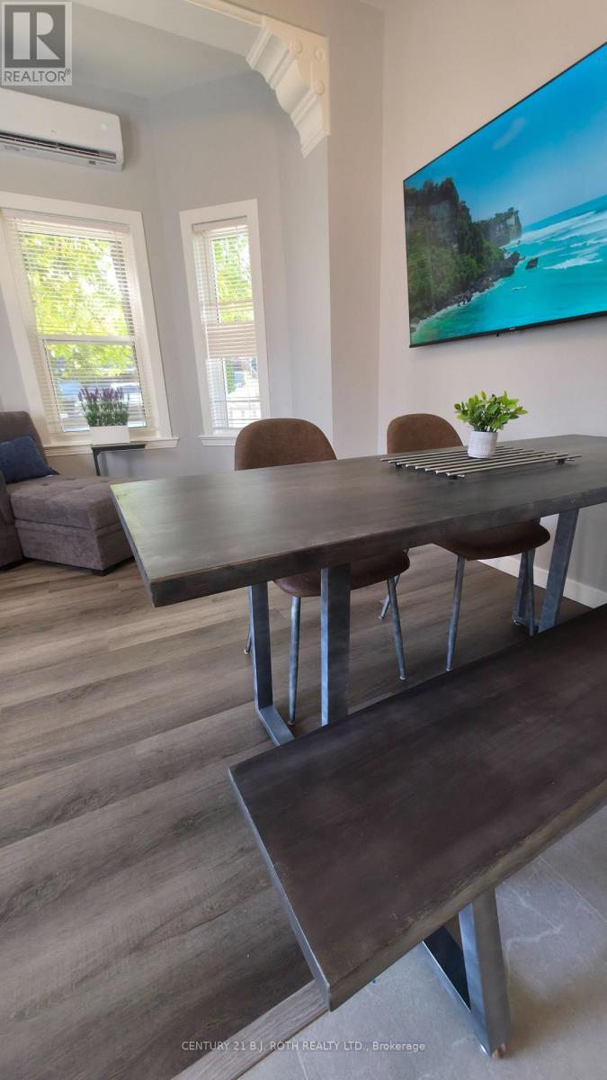 A dining room with a wooden table and chairs.