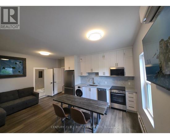 A modern kitchen with a dining table and chairs.
