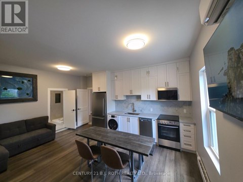 A modern kitchen with a dining table and chairs.
