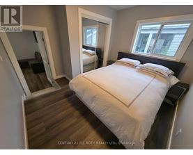 A bedroom with a large bed and a mirror on the wall.