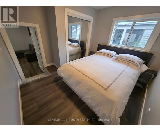 A bedroom with a large bed and a mirror on the wall.