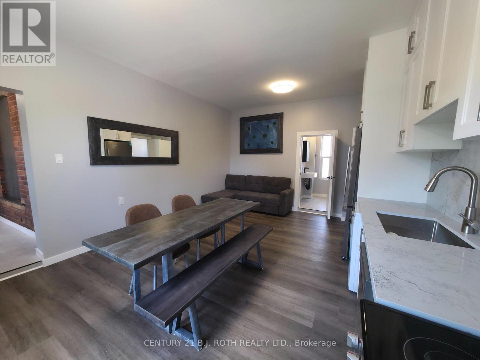 A kitchen with a table and chairs in the middle of the room.