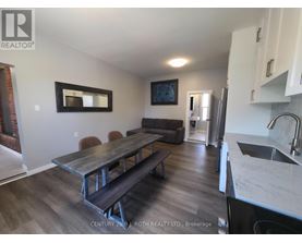 A kitchen with a table and chairs in the middle of the room.
