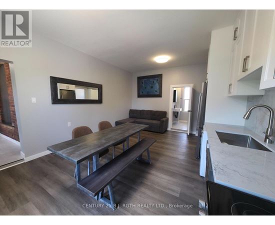 A kitchen with a table and chairs in the middle of the room.