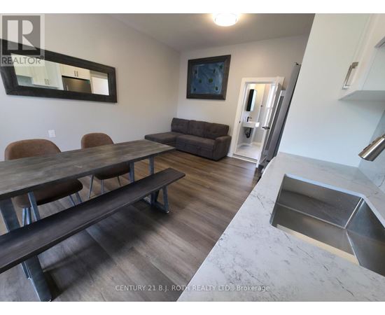 A dining room with a wooden table and chairs.