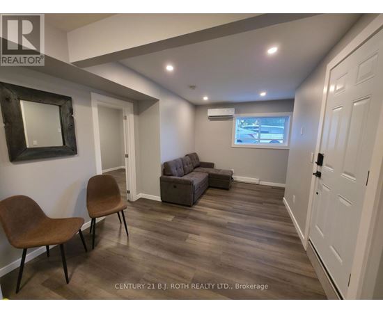 A living room with a brown chair and a grey couch.