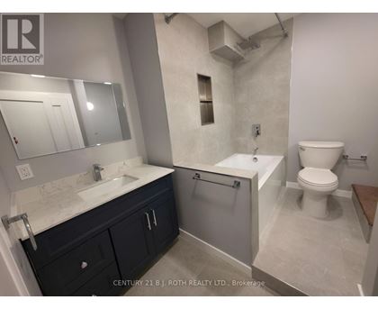 A bathroom with a sink, toilet, and bathtub.