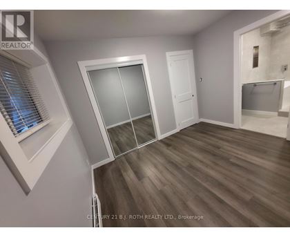A room with a sliding door and a window with blinds.