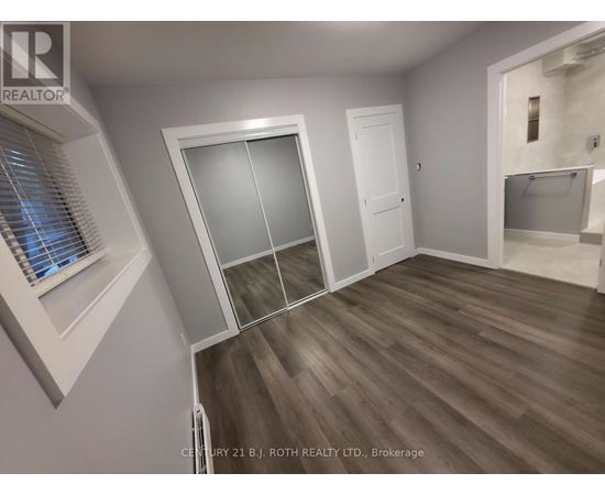A room with a sliding door and a window with blinds.