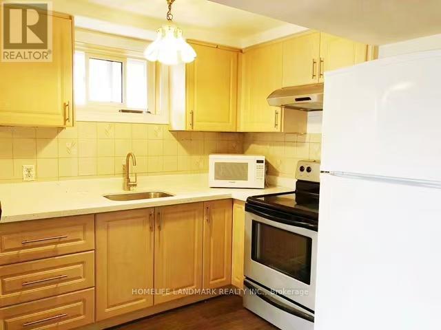 A kitchen with wooden cabinets and a white refrigerator.