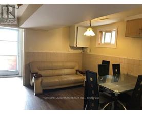A living room with a couch, chairs, and a dining table.