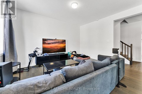 A living room with a grey couch and a flat screen TV.