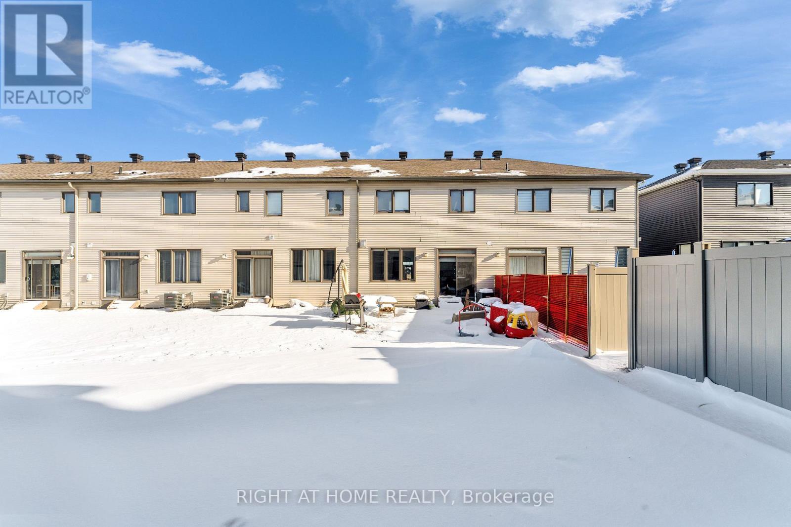 A snowy scene with a building and a sign that says "REALTOR".