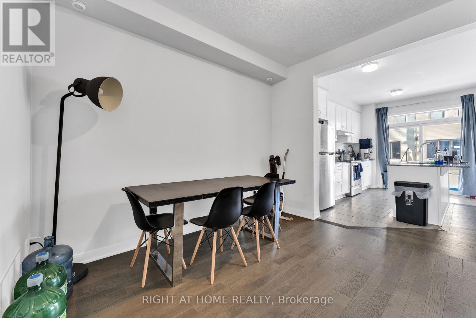 A dining room with a table and chairs.