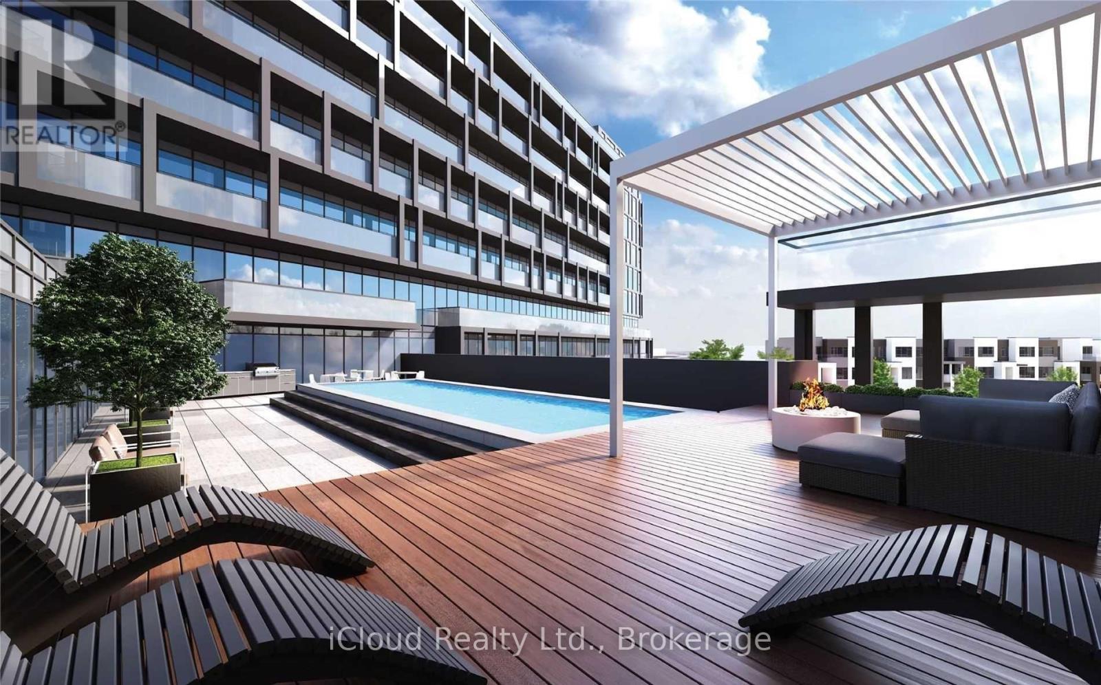A modern building with a pool and a wooden deck.