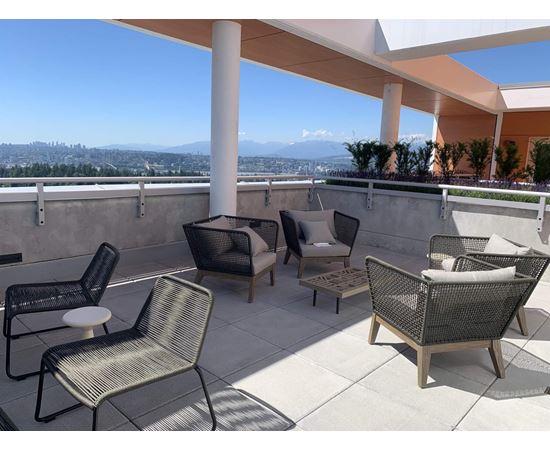 A patio with a view of the city and mountains.
